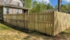 high wooden picket fence